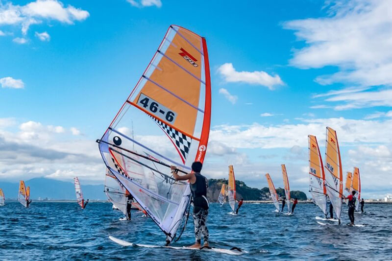 湘南・江ノ島とマリンスポーツのウィンドサーフィンの大会に出場している選手たちと海